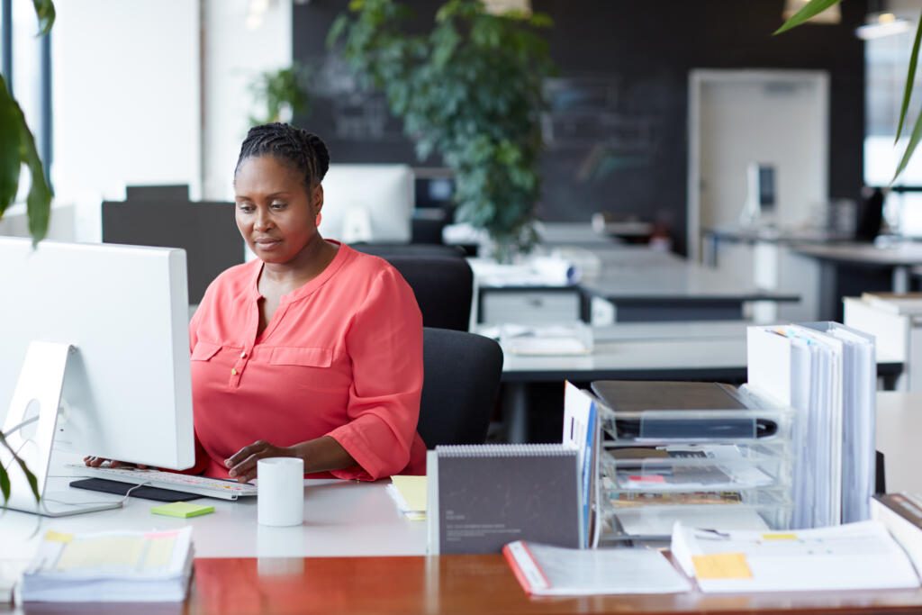 women working on computer digitizing documents for electronic delivery