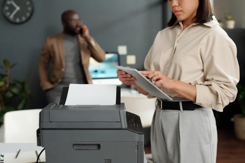 Cropped shot of young female office manager using tablet in front of camera